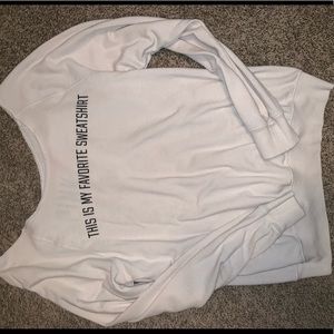 Worn, light weight off the shoulder sweater